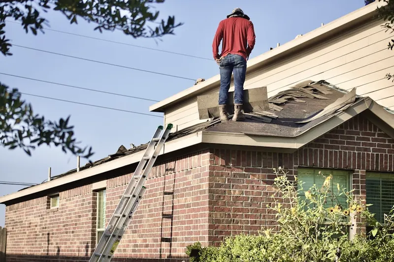 Professional roofer working on a residential roof in Bloom Crossing